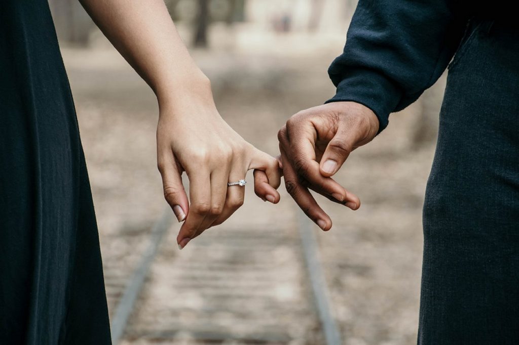 A couple holding hands.